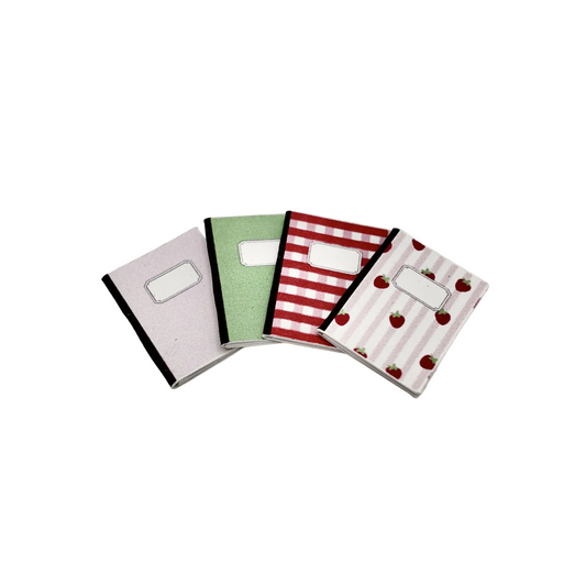 Four miniature 1:12 scale notebooks with different patterns on a white background